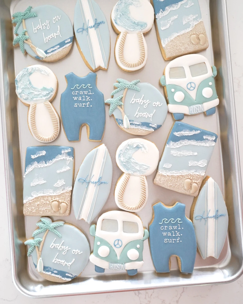 Blue baby shower cookies with bottles and rattles